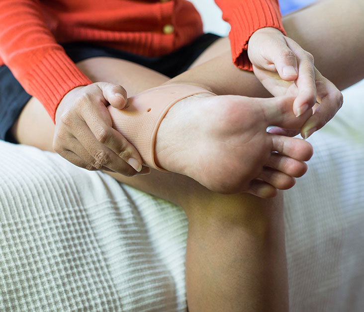 Stock image of girl sitting and showing heel spur of her left leg