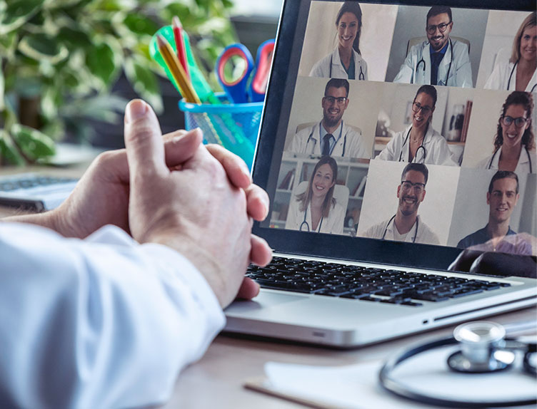 stock image showing a laptop with photos of doctors on it