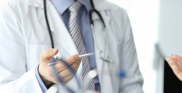 Close up shot of doctor holding out stethoscope.