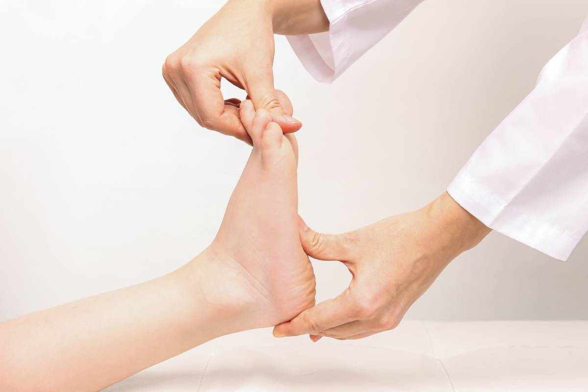 Concept image of doctor checking heel pain in some children